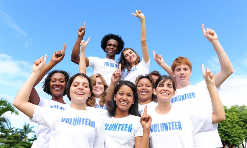 portrait of a happy and diverse volunteer group hands raised portrait of a happy and diverse volunteer group hands raised